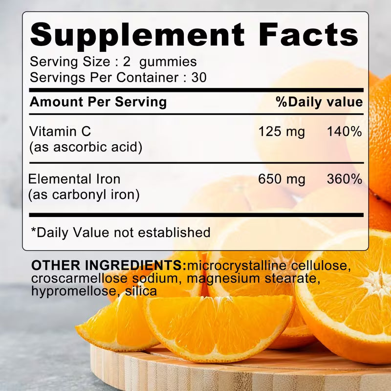 Supplement facts label with vitamin C and iron content, surrounded by oranges.