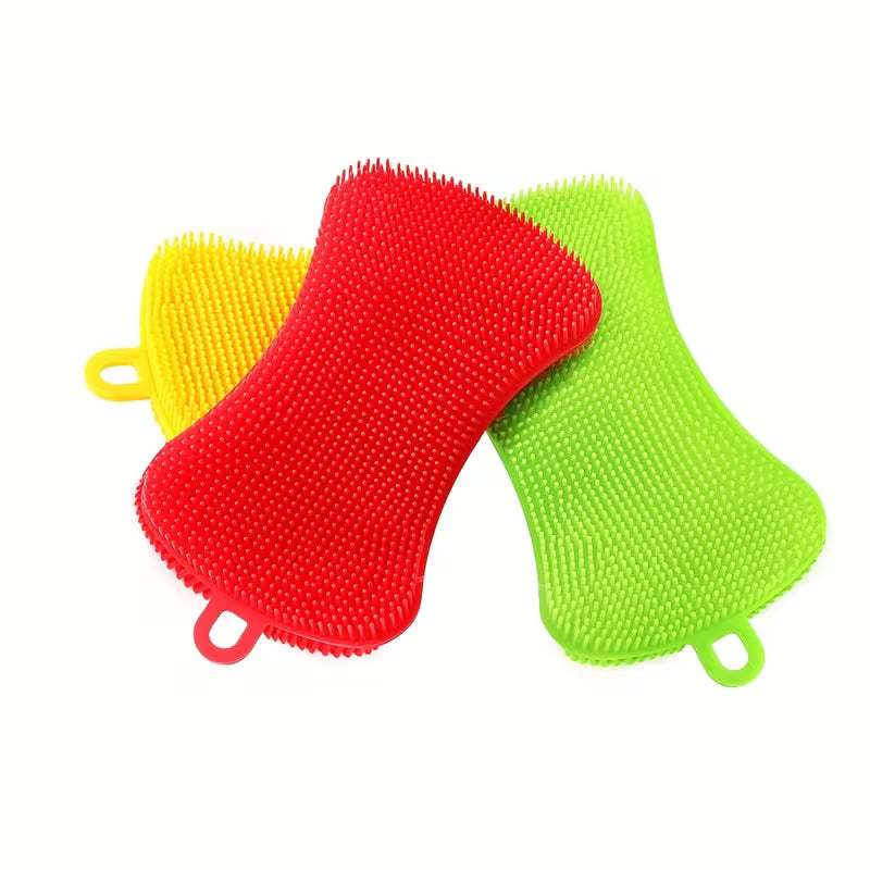 Three colorful scrubbing pads (red, green, yellow) on a white background