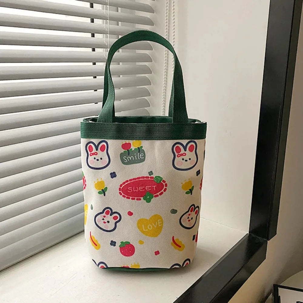 Bucket Bag Portable Cute Animal Pattern Graffiti Handbag Cartoon Print Cylindrical Bag Canvas Bento Bag Handheld Lunch Box Bag Peaceful Pleasures Health and Wellness green
