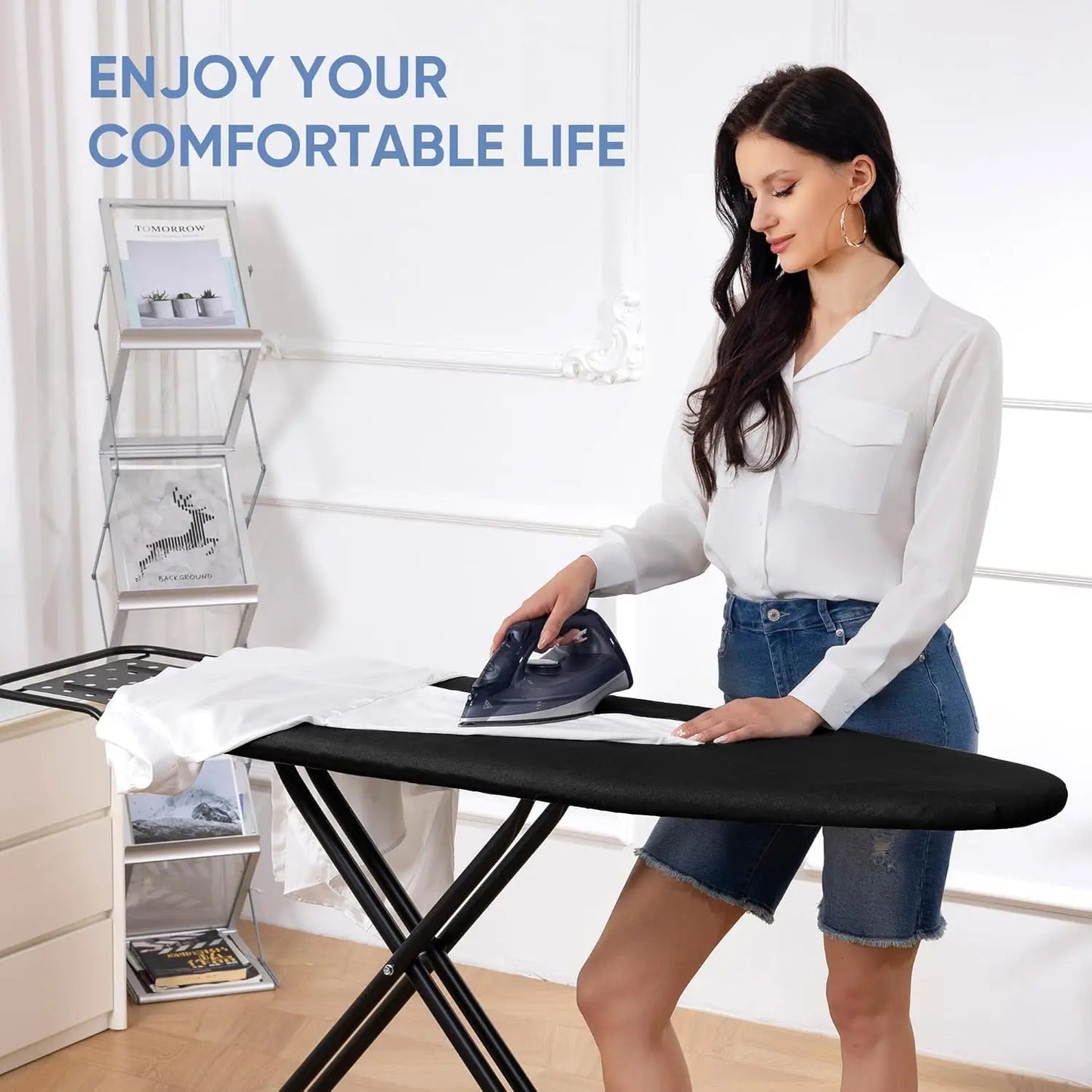 Woman ironing clothes on a black ironing board with text 'Enjoy Your Comfortable Life' in a bright room.