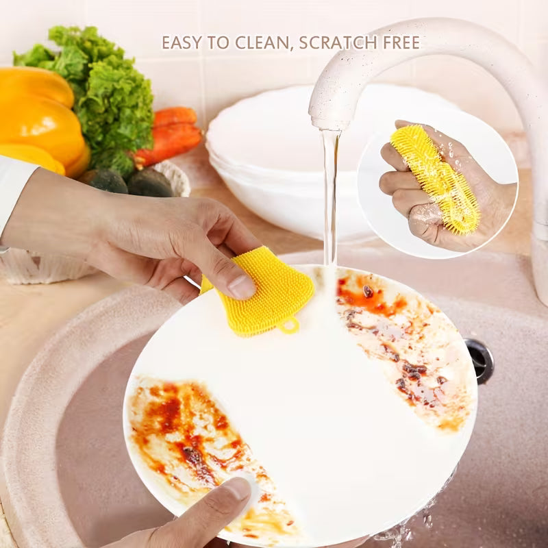 Person cleaning a dirty plate with a yellow scrubber, surrounded by vegetables.