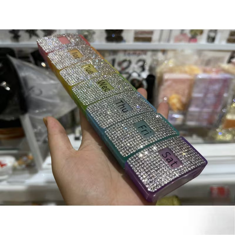 Weekly planner with rhinestone embellishments held by a hand in a store setting