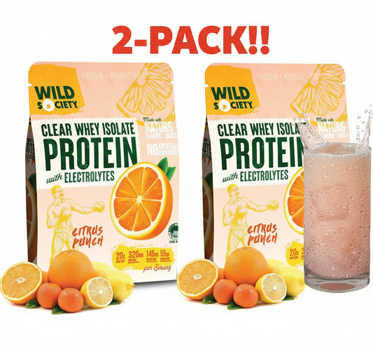 Two packages of Wild Society protein powder with citrus punch flavor, surrounded by oranges and lemons, and a glass of the protein shake.