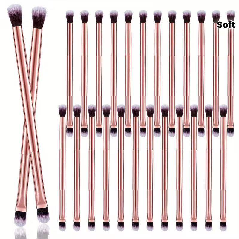 Set of makeup brushes with rose gold handles on a white background