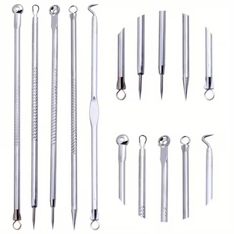 Set of metal skincare tools on a white background