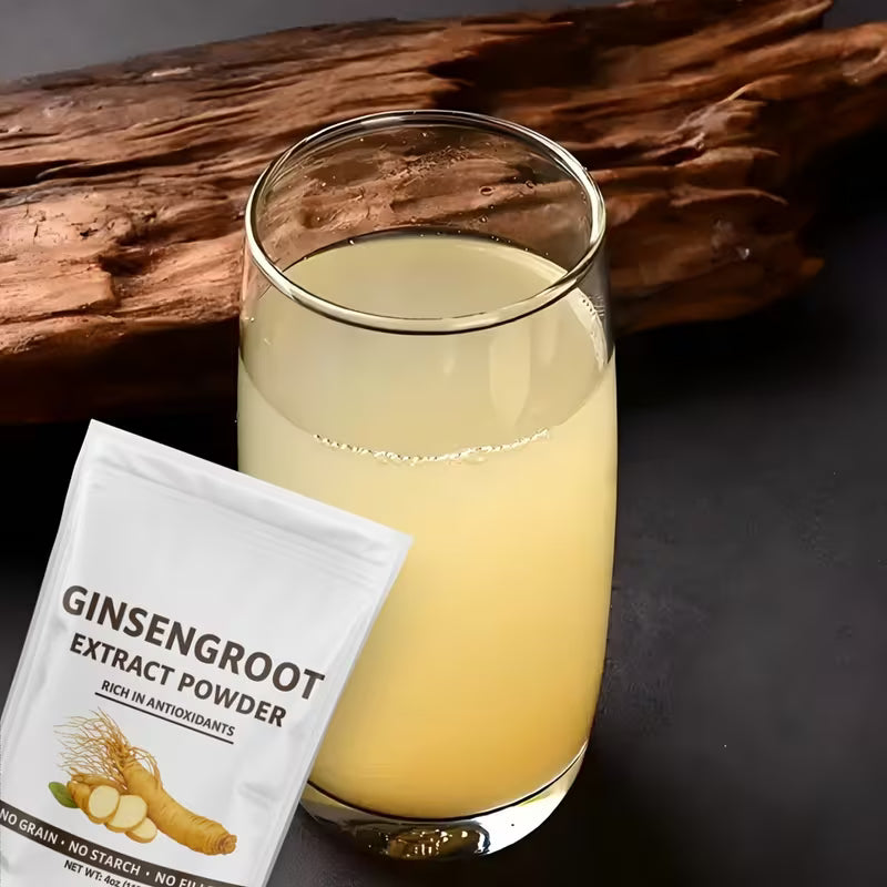 Glass of ginsengroot drink with a packet of ginsengroot extract powder on a dark background