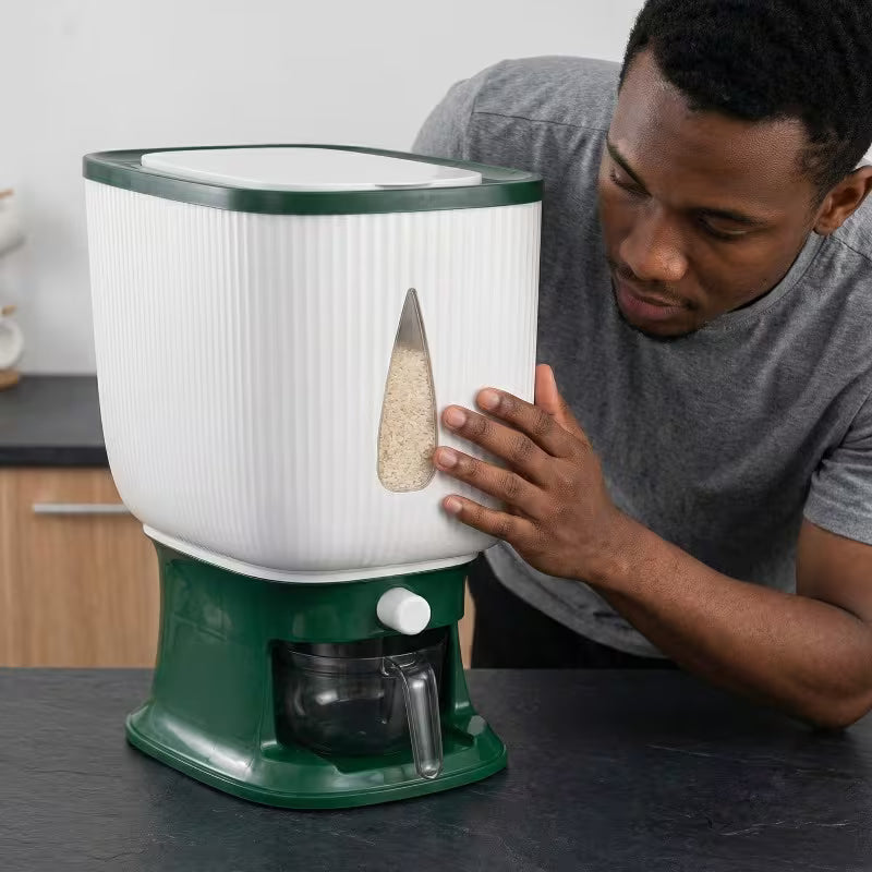 Person interacting with a green and white kitchen appliance on a countertop.