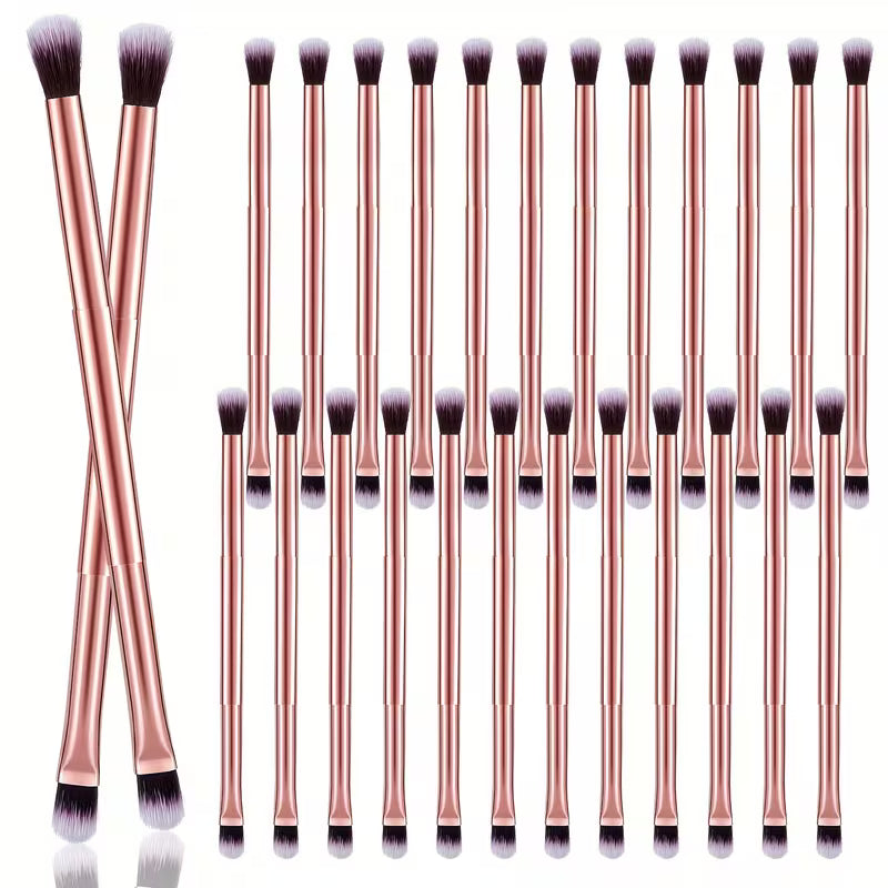 Set of 20 makeup brushes with rose gold handles on a white background