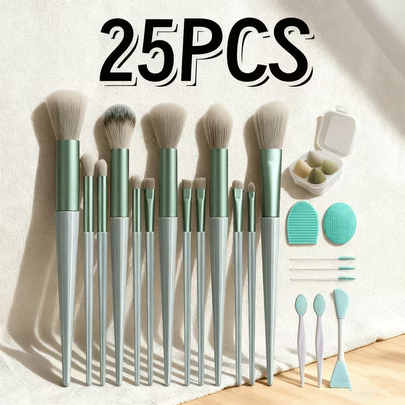 Set of 25 makeup brushes with green handles and silver ferrules on a light background.