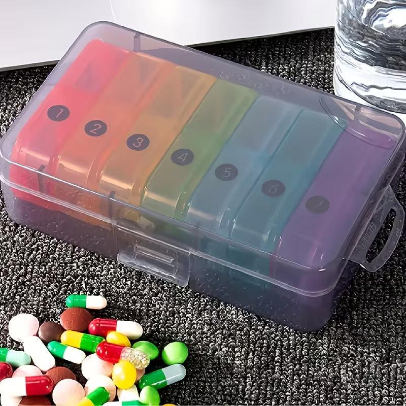 Colorful pill organizer with assorted pills on a textured surface