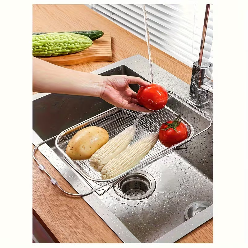 Person washing vegetables under running water in a kitchen sink with a metal strainer.