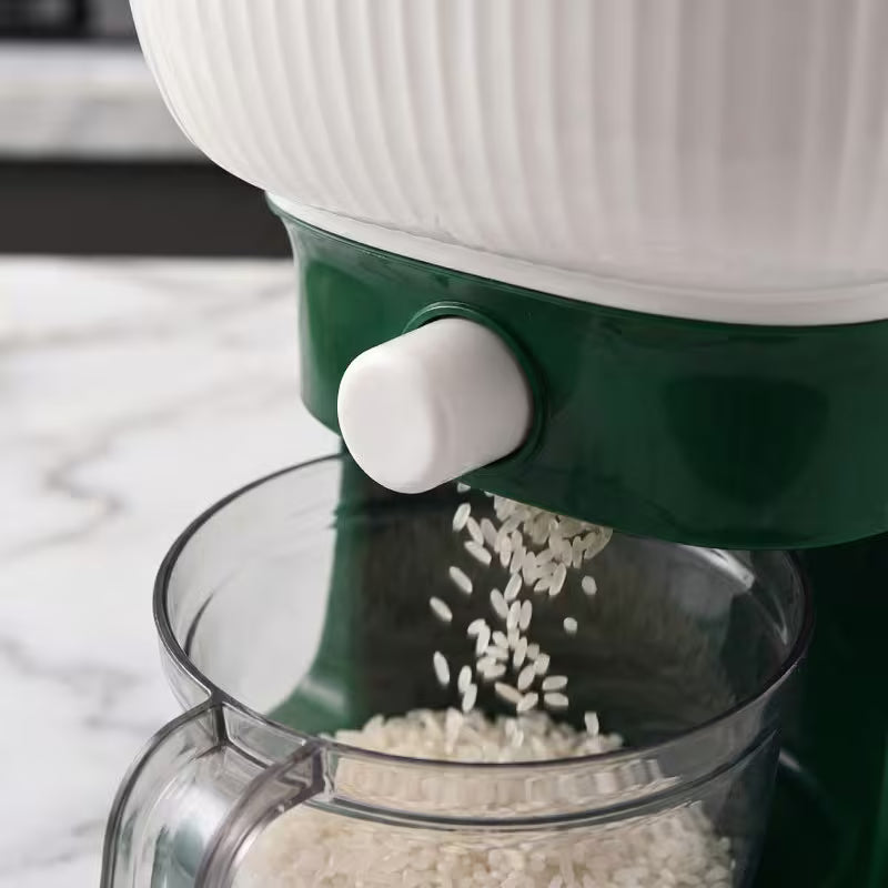 Green and white kitchen appliance with a clear container filled with rice on a marble surface.