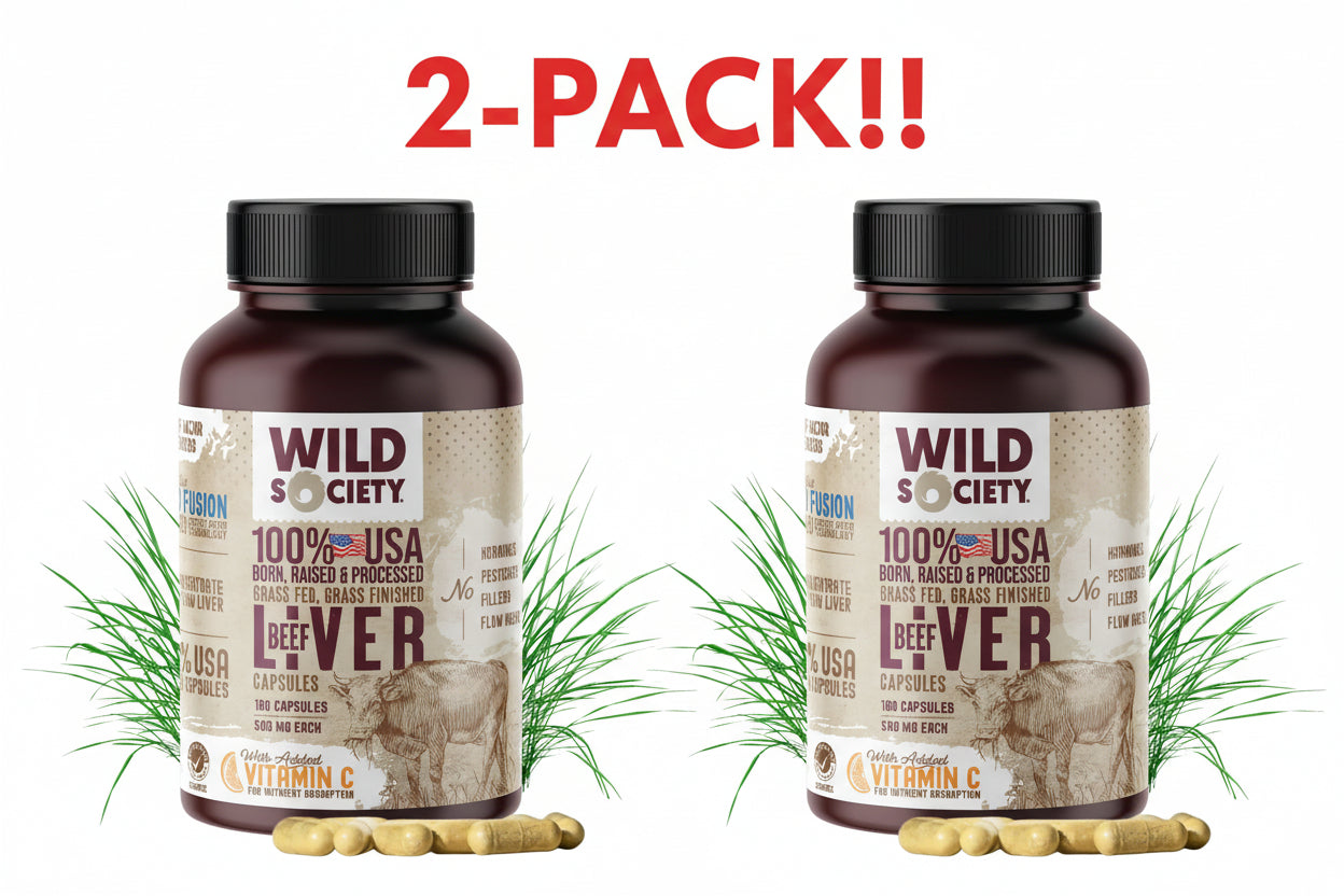 Two bottles of Wild Society 100% USA beef liver capsules with grass in the background.