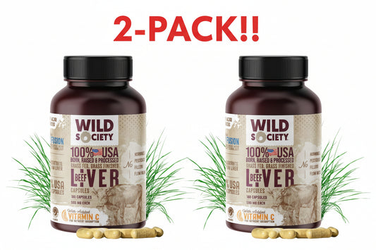 Two bottles of Wild Society 100% USA beef liver capsules with grass in the background.