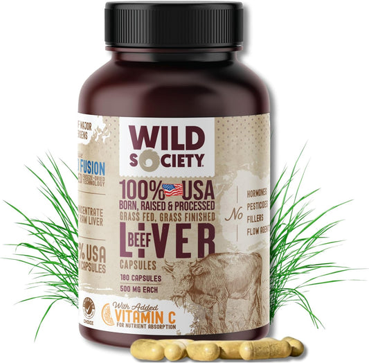 Wild Society beef liver supplement bottle with grass and capsules on a white background