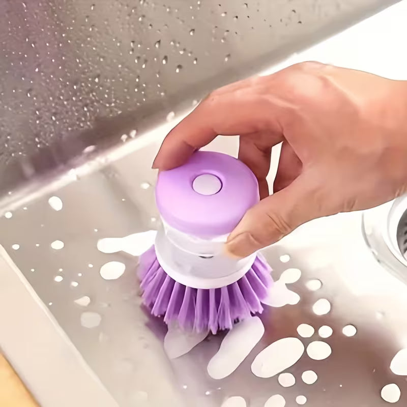 Purple kitchen scrubber held by a hand over a sink