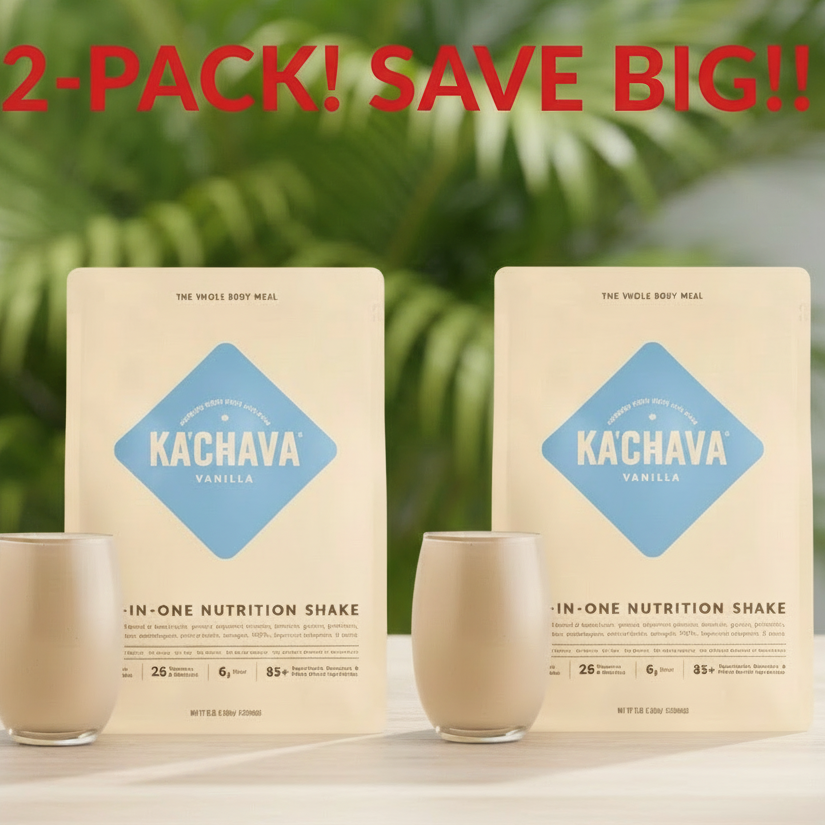 Two Kachava Vanilla nutrition shake packages with two glasses on a wooden surface with a green plant background.