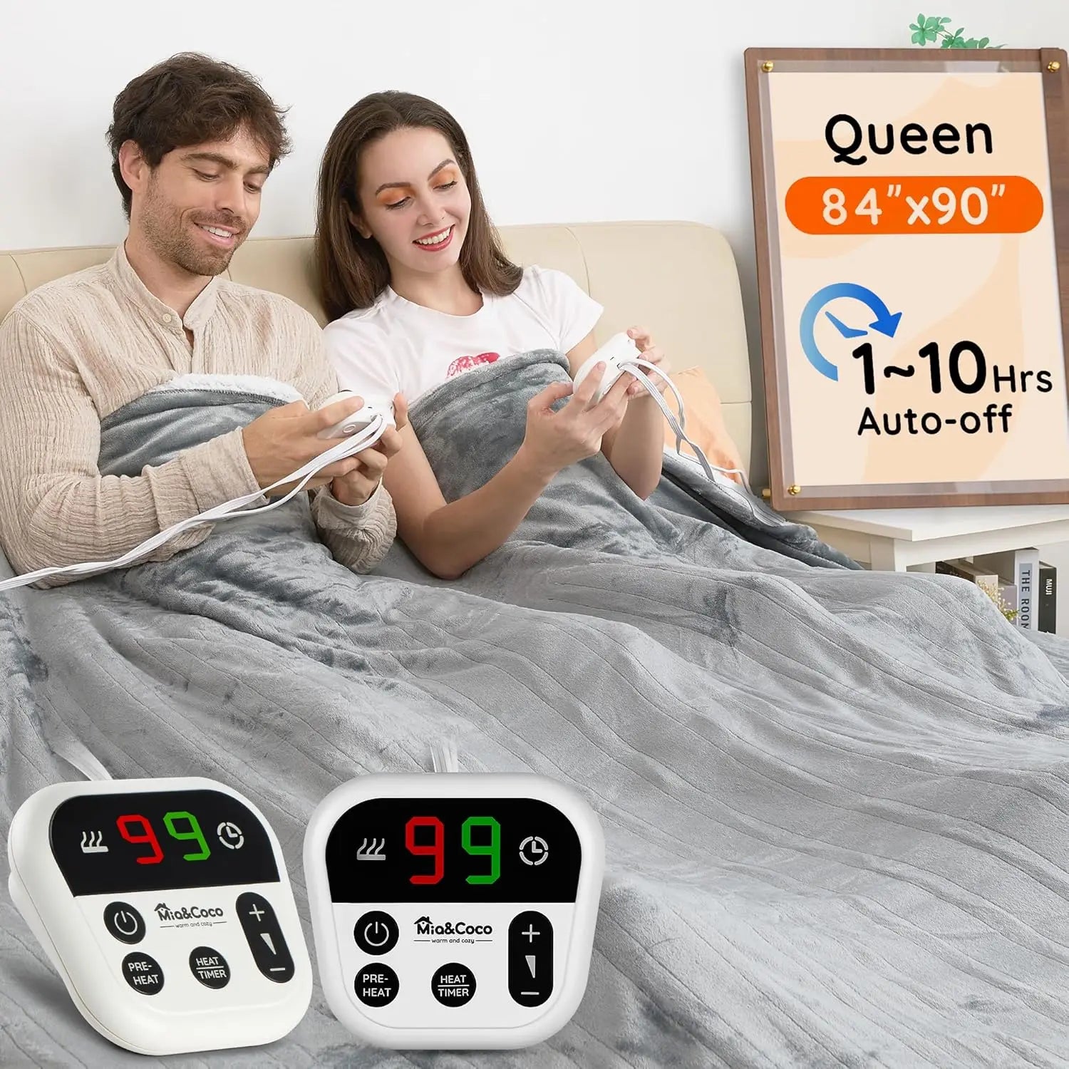 Man and woman using a heated blanket with digital controllers, surrounded by a Queen size blanket and controller display.