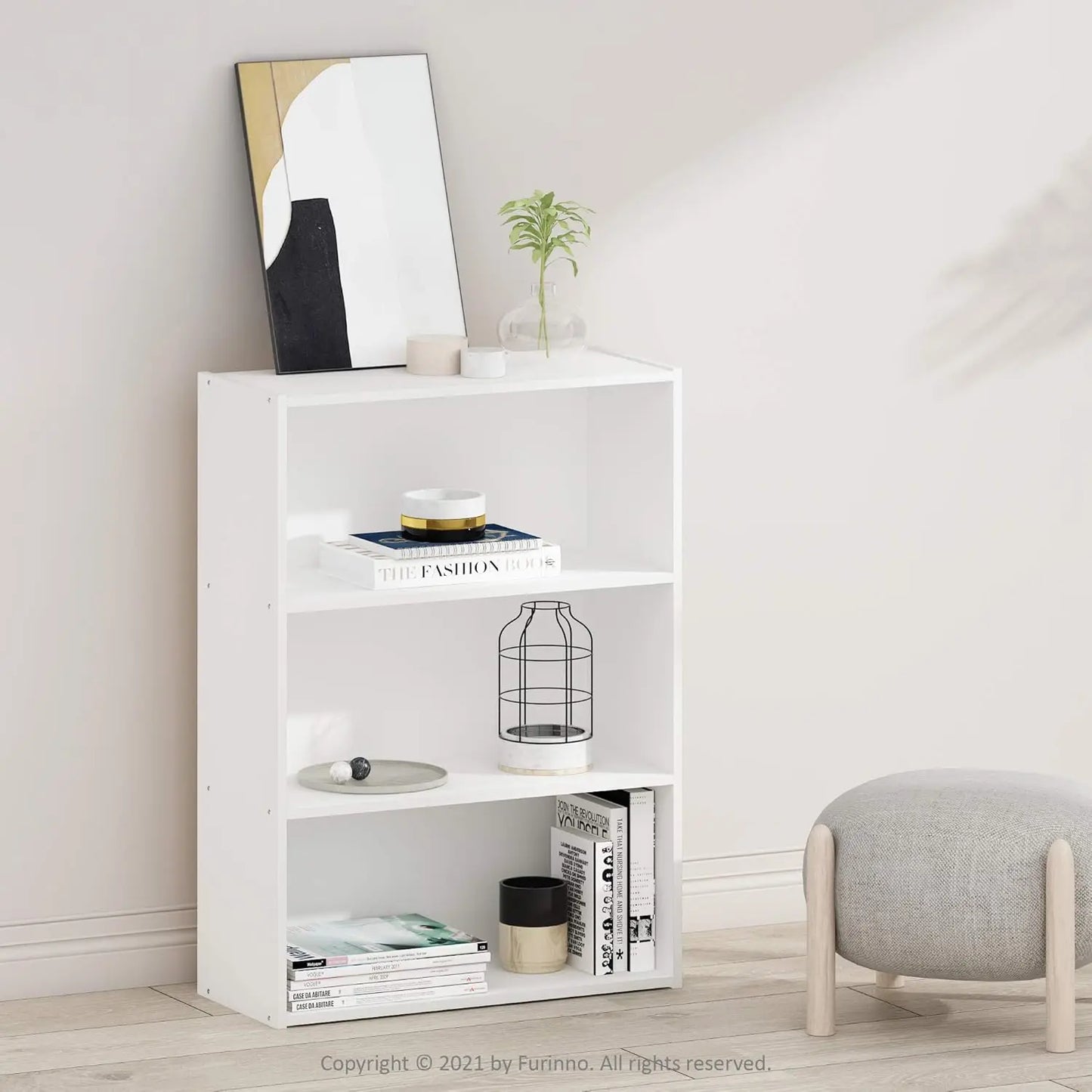 White bookshelf with decorative items in a room setting