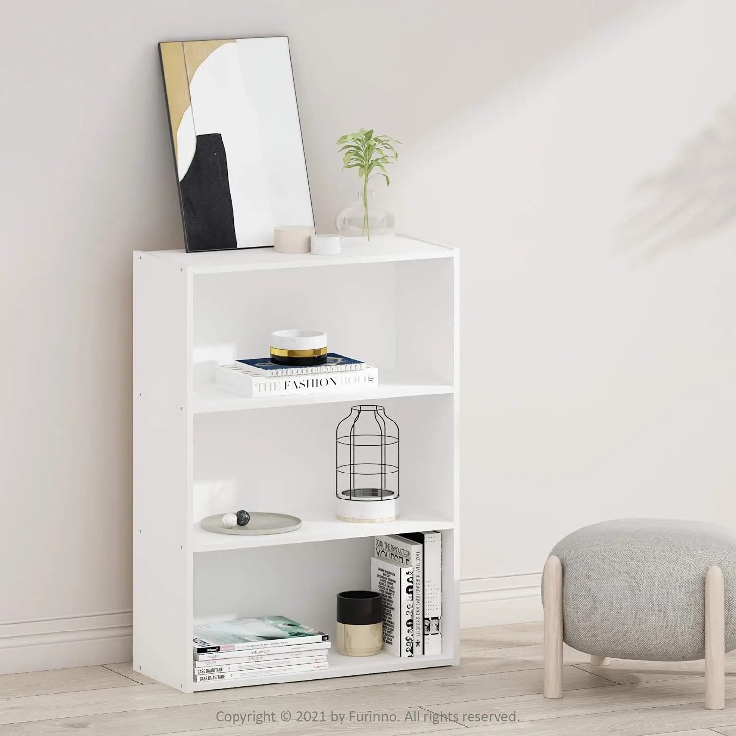 White bookshelf with decorative items in a room setting