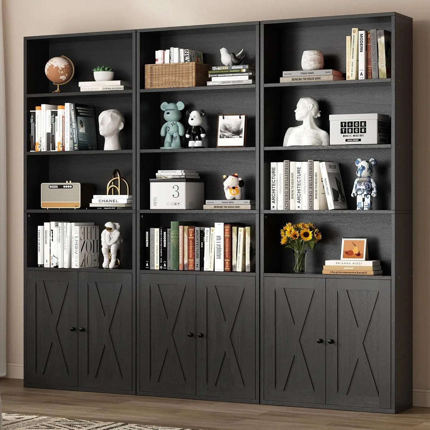 Black bookshelf with decorative items against a beige wall