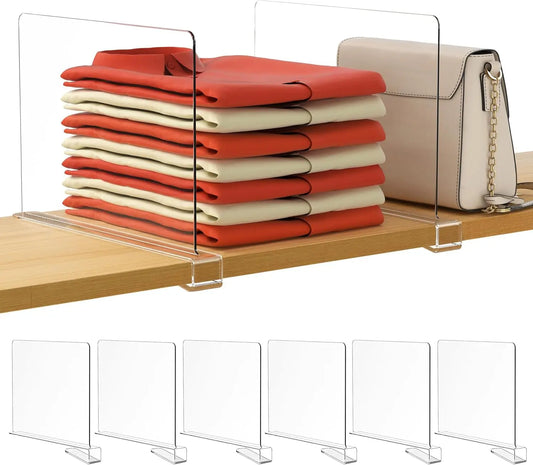 Clear acrylic shelf divider with folded red and beige fabric on a wooden shelf.