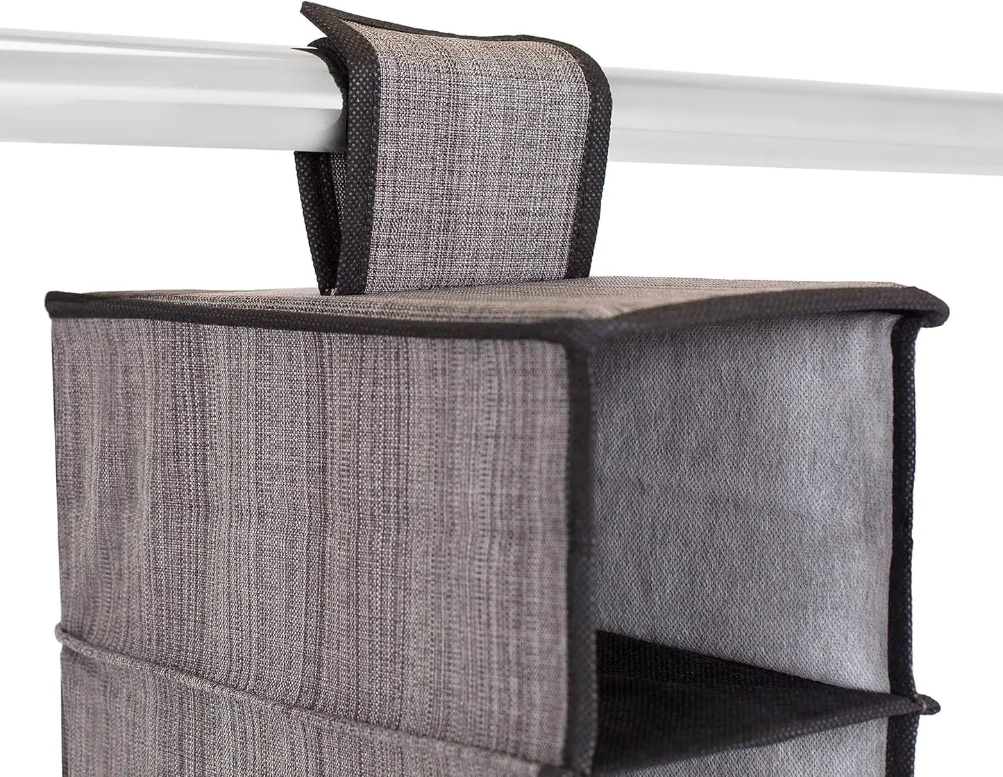 Gray fabric storage bag with black trim hanging on a white rod.