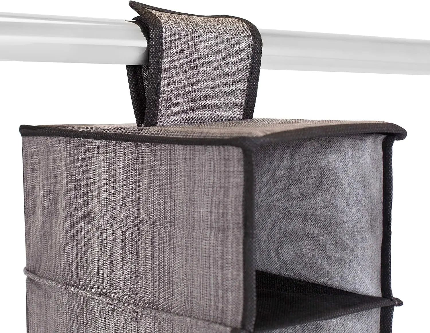 Gray fabric storage bag with black trim hanging on a white rod.