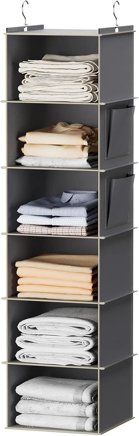 Gray shelving unit with folded clothes on shelves