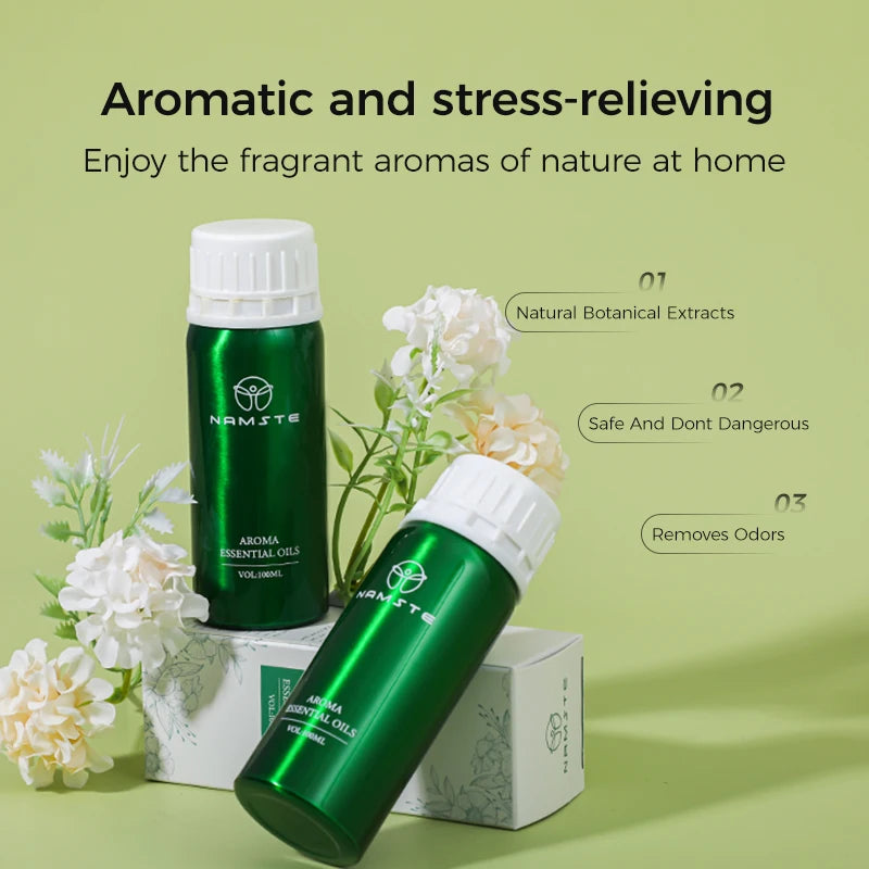 Green aroma essential oil bottles with white flowers on a green background