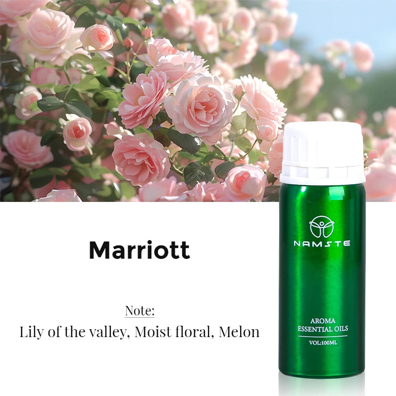 Green aroma essential oils bottle with pink flowers in the background