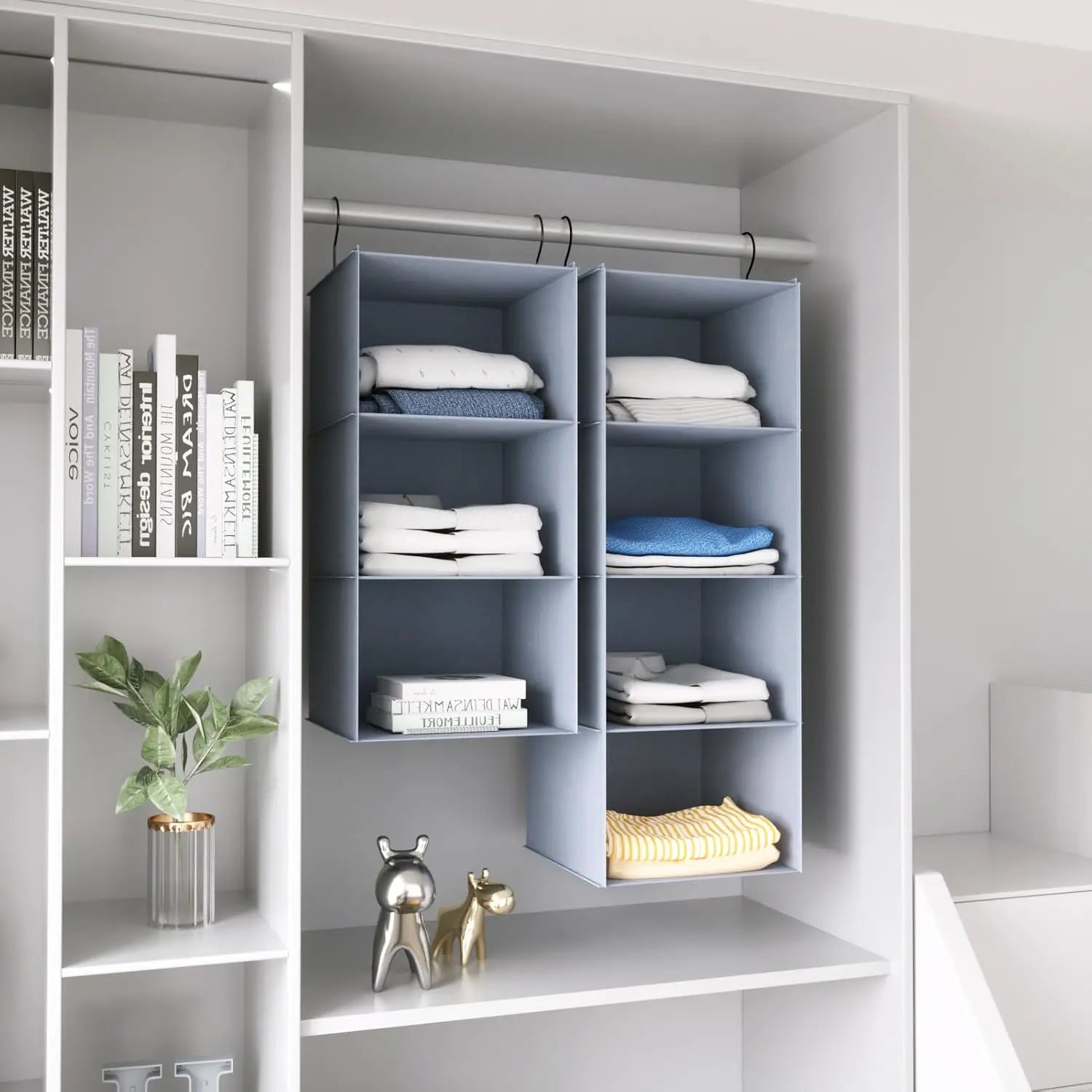 Closet with shelves containing folded clothes, books, and decorative items.