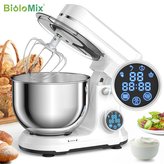 White stand mixer with digital display and mixing bowl on a white background, surrounded by baked goods and salad.