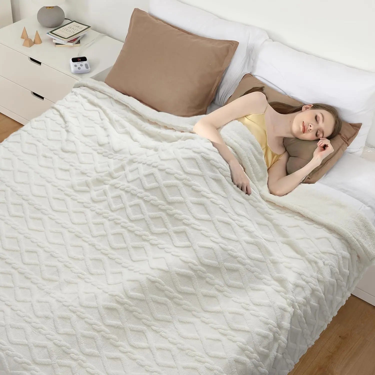 Woman lying on a bed under a white textured blanket in a bedroom setting.