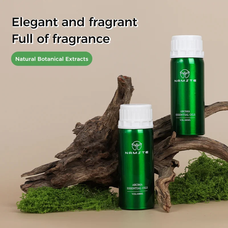 Two green essential oil bottles with white caps on a natural background