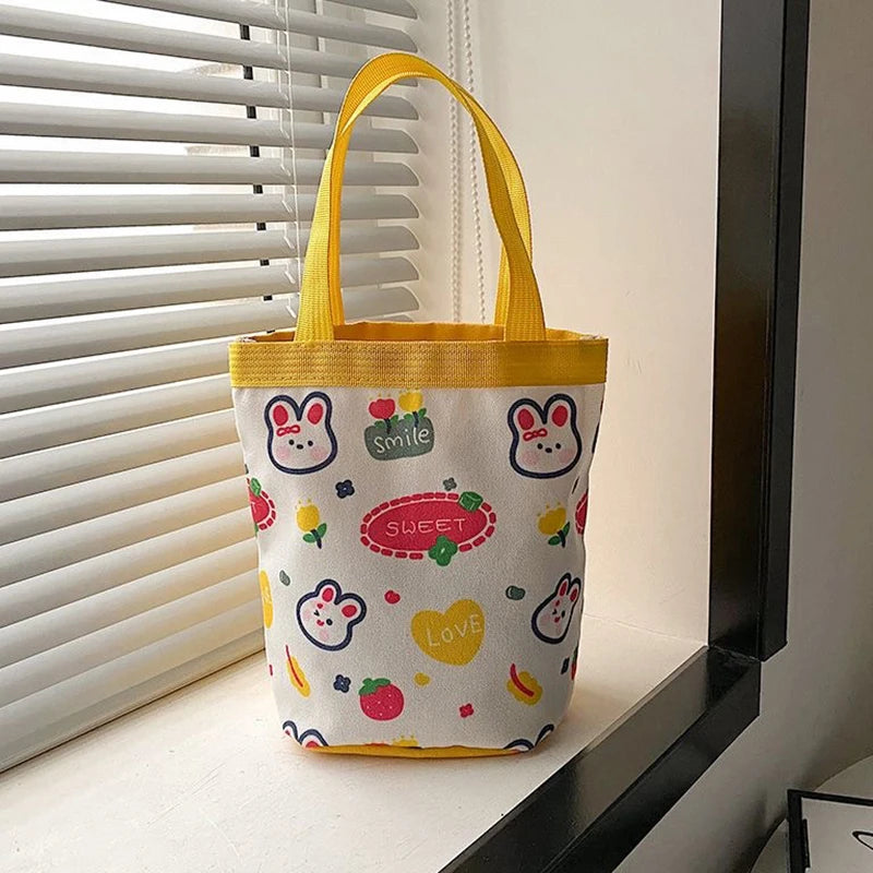 Bucket Bag Portable Cute Animal Pattern Graffiti Handbag Cartoon Print Cylindrical Bag Canvas Bento Bag Handheld Lunch Box Bag Peaceful Pleasures Health and Wellness yellow