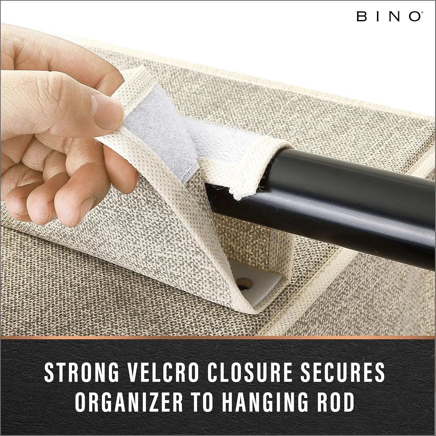 Hand using a strong Velcro closure to secure an organizer to a hanging rod on a textured surface.