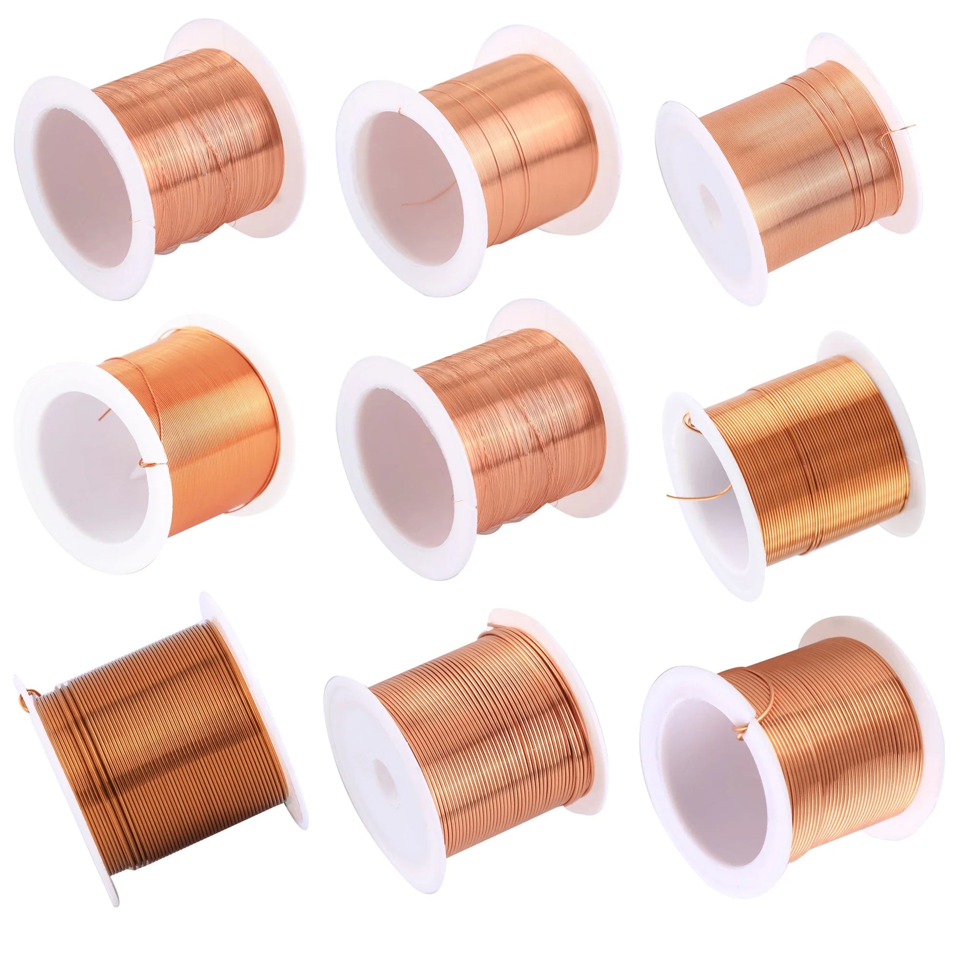 Nine spools of copper wire on white background