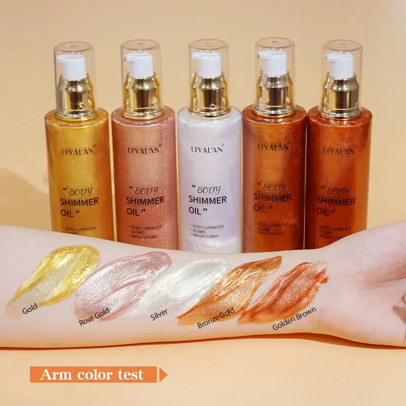Five bottles of LIVYAN body shimmer oil with color swatches on an arm against a beige background.