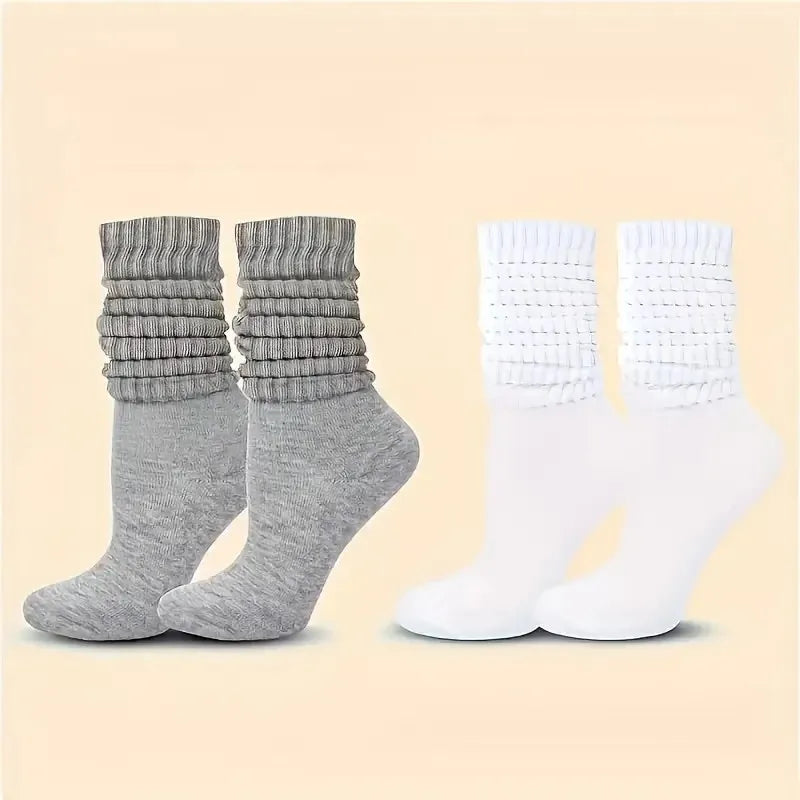 Three pairs of solid-colored black, white, and gray stackable socks, stylish and casual, versatile for various outfits. Peaceful Pleasures Health and Wellness