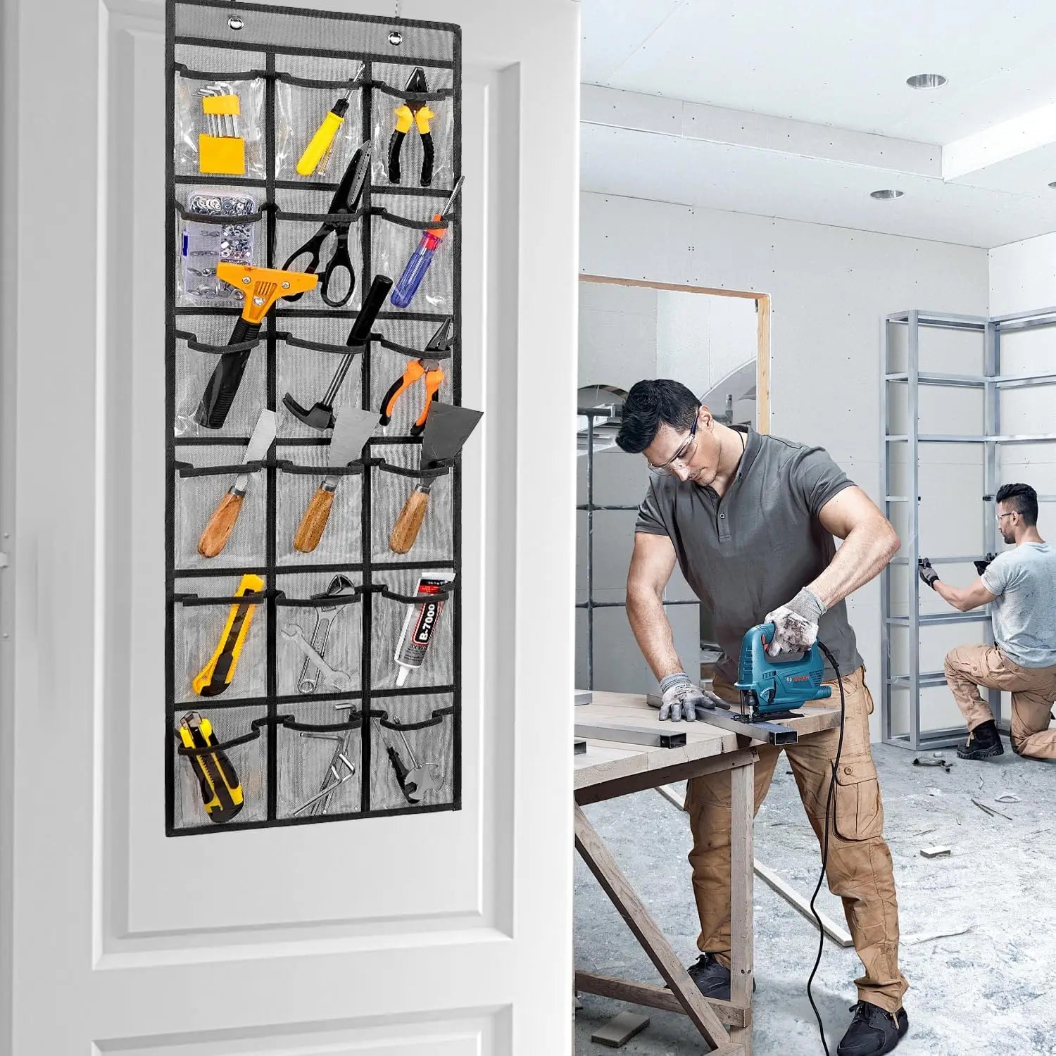 Man working on a project with tools organized on a door panel in a workshop setting.