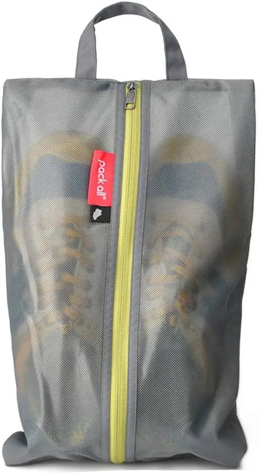 Gray mesh shoe bag with yellow zipper containing a pair of sneakers on a white background