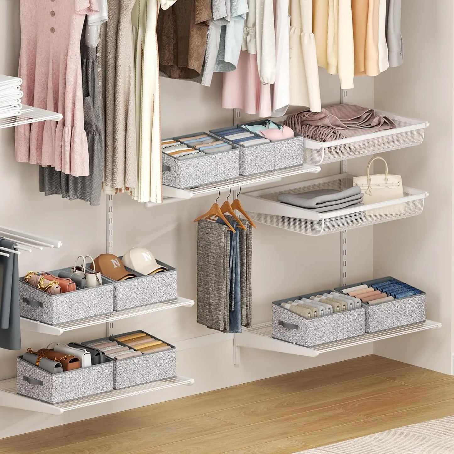 Closet organization system with hanging clothes, folded garments, and storage bins.
