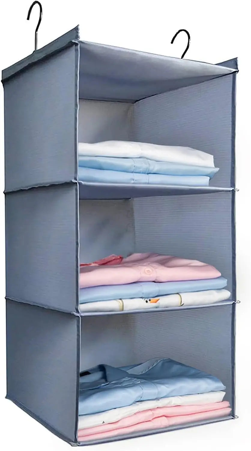 Gray hanging organizer with folded clothes on a white background