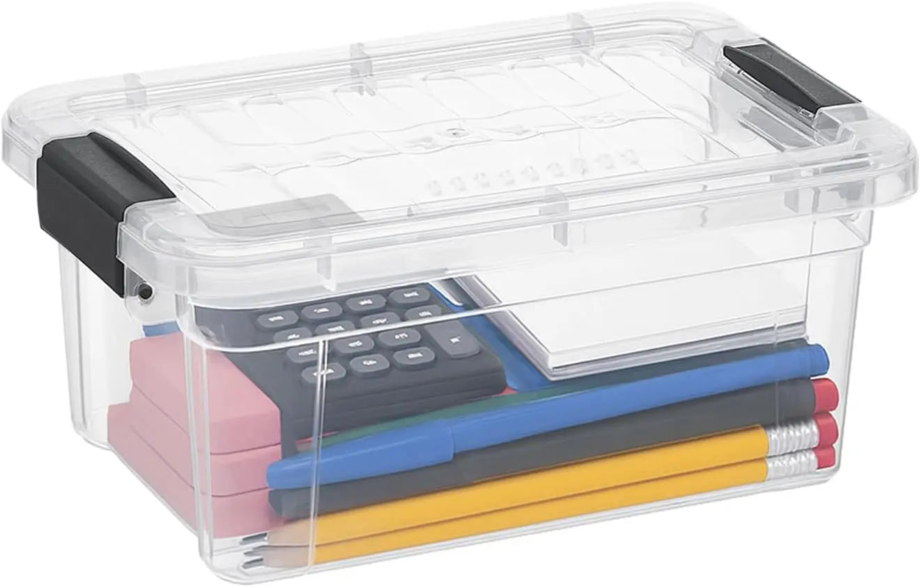 Clear storage box with black handles containing stationery items like pencils and a remote control.