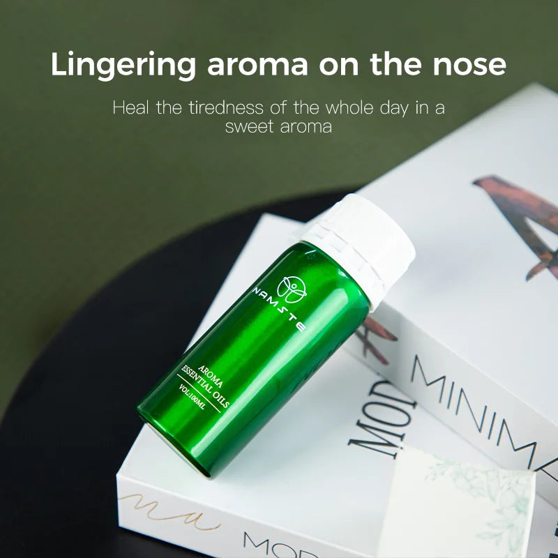 Green essential oil bottle on a magazine with text about aroma and tiredness.