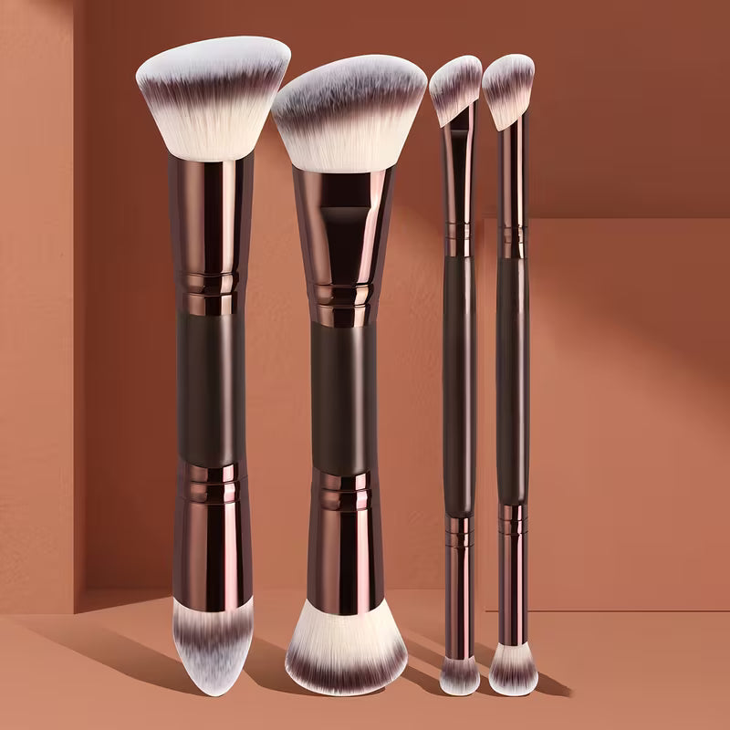 Set of makeup brushes with rose gold and black handles on a brown background