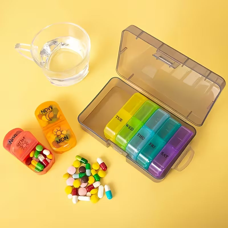 Colorful pill organizer with assorted pills and a glass of water on a yellow background