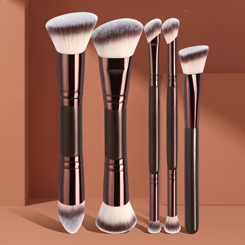 Set of makeup brushes with brown and rose gold handles on a brown background