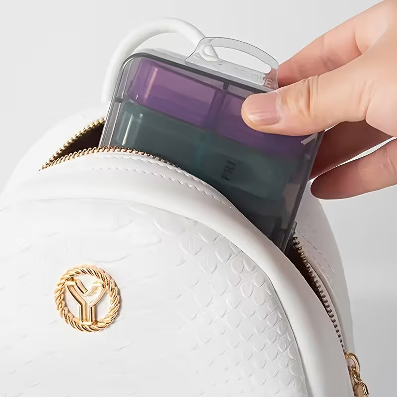 Hand holding a phone case over a white textured bag with a gold emblem.